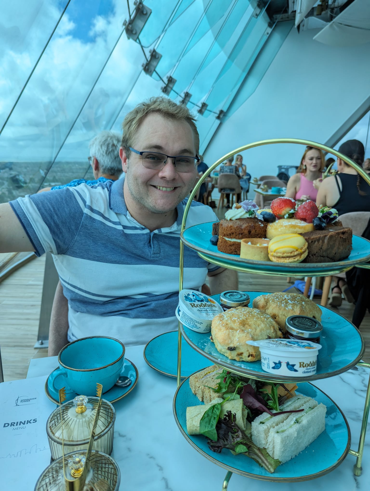 James looking pretty happy sat with a tray of cake in front of him