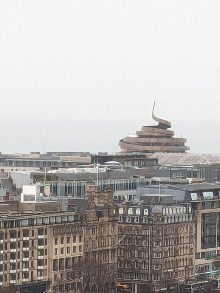 A building that looks a bit like a poo made out of metal - or maybe a spiral ribbon if you look closely