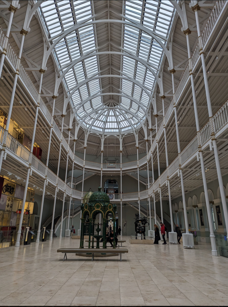 The magnificent interior of the museum with huge glass windows and decorative iron supports