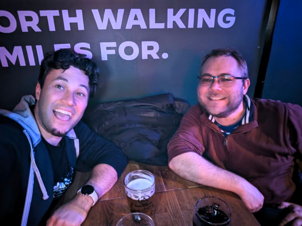 James and Daniel hanging out in the The Scottish Stores pub. They are sat at a table with beers in front of them.