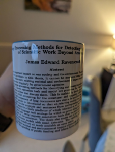 a mug with the abstract from James' phd thesis printed on it