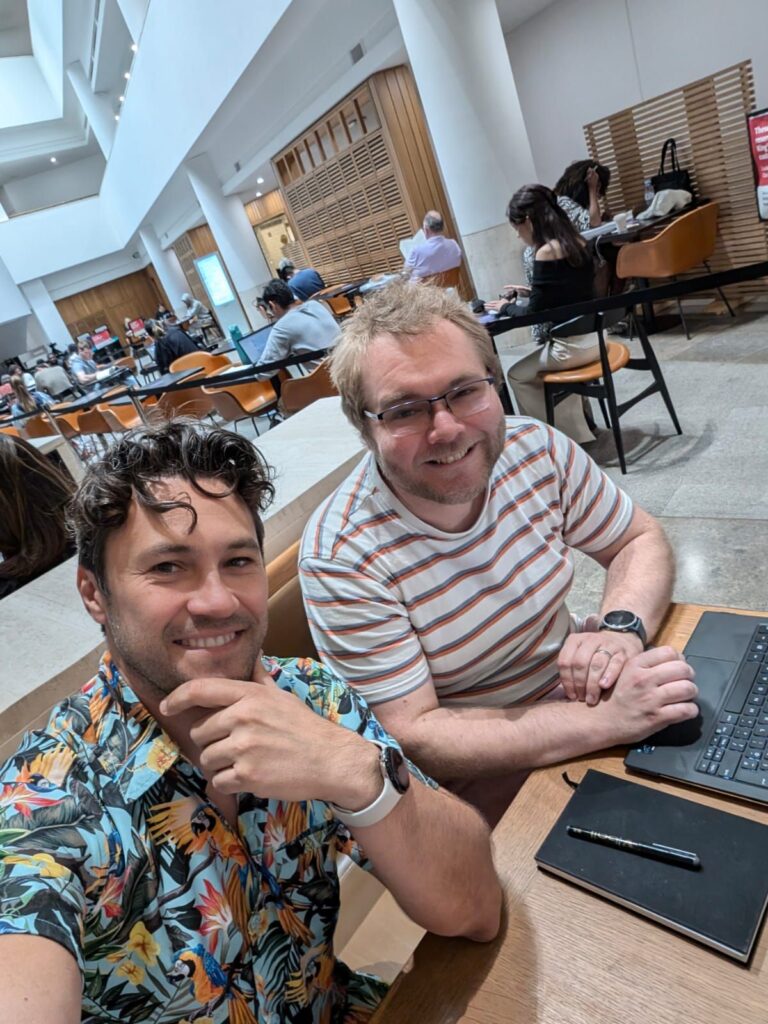 James and Daniel selfie looking at camera sat in the national library